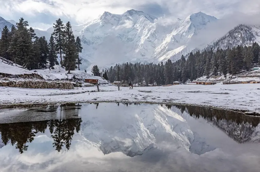 Nanga Parbat reflected in a lake at Fairy Meadows, a beautiful winter landscape in Pakistan