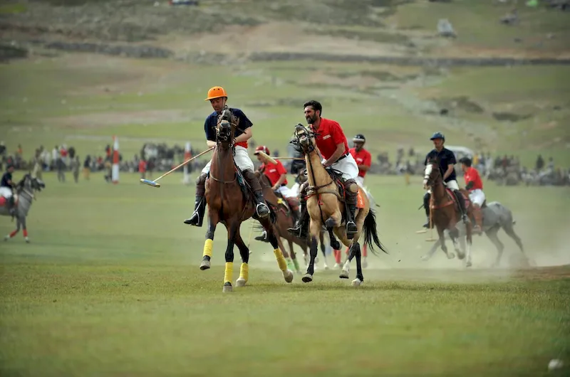 Thrilling polo match between rival teams from Chitral and Gilgit at the world’s highest polo ground on Shandur Pass, showcasing Pakistan’s traditional sport amid stunning mountain vistas.