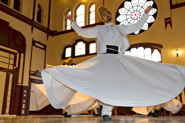 A whirling dervish performs the traditional Sufi Sema ritual, symbolizing spiritual ascent and mystical devotion in Pakistan