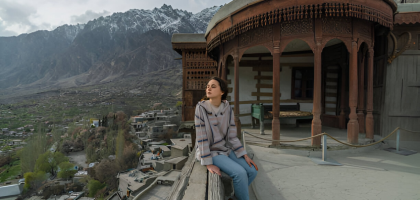 baltit-fort-woman-balcony-view-hunza Woman looking out from the balcony of Baltit Fort in Hunza Valley, Gilgit Baltistan